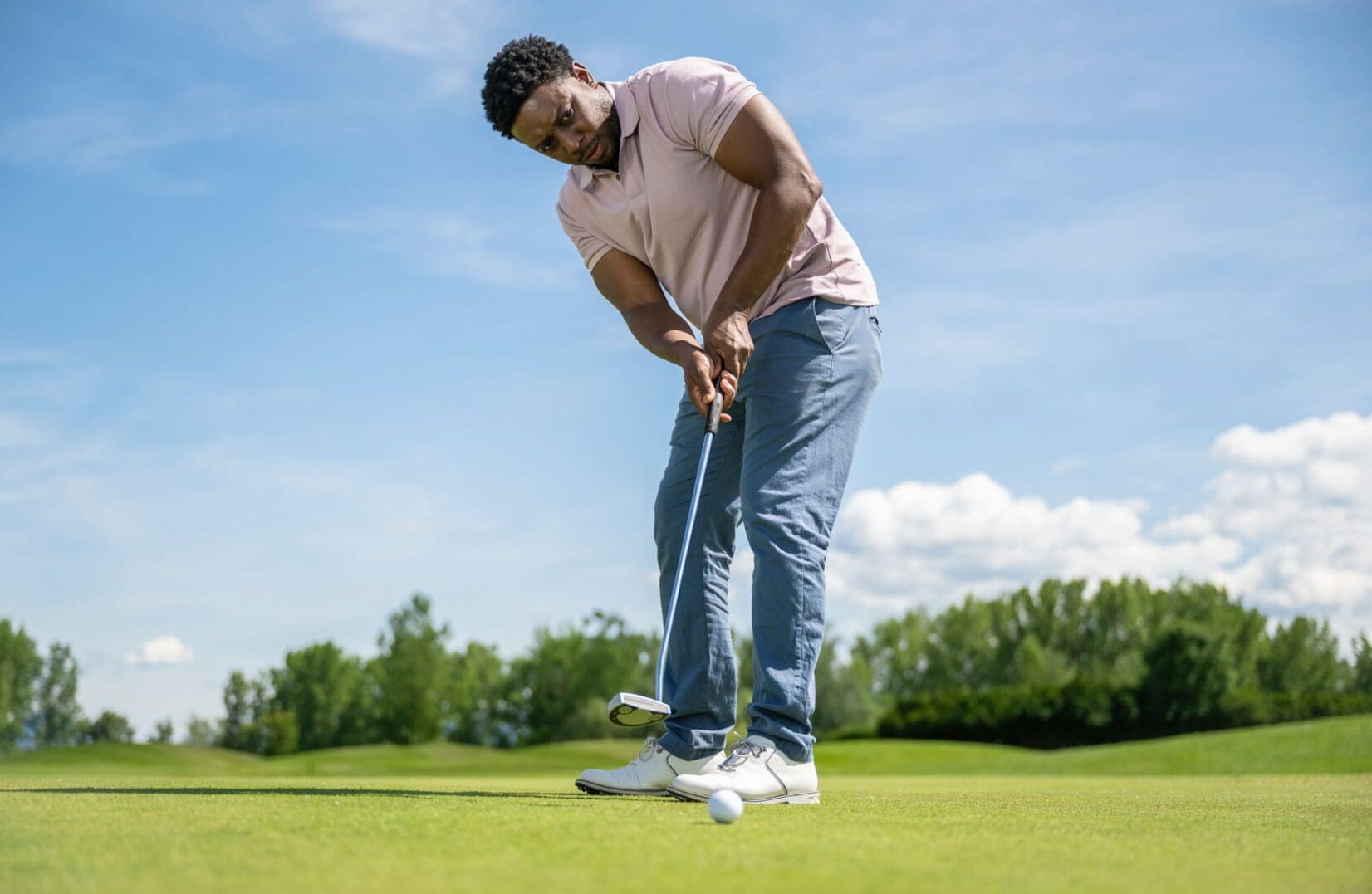Man putting on a golf course