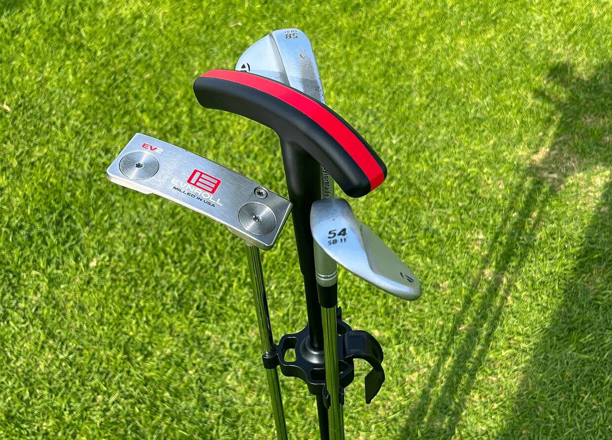 Golf clubs on green grass